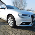 Srebrne Audi A4 Avant na parkingu, widok z przodu.